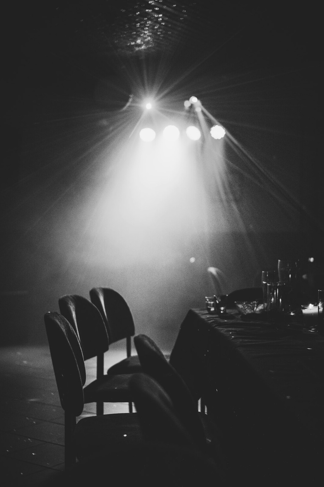 Empty stage with two chairs and spotlights